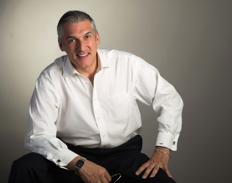 a man wearing a white button down shirt and black dress pants