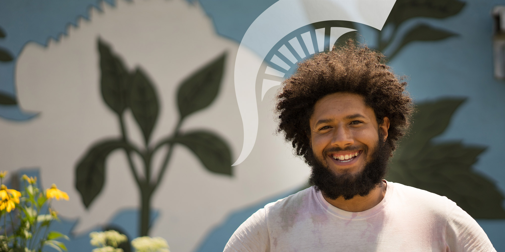 image of a man with brown hair and beard, there is a graphic of a spartan helmet on top of his head