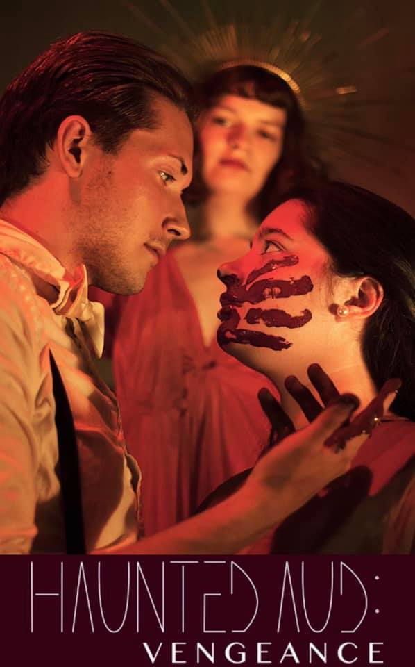 Side view of a man and woman looking at each other with a deity looking over them. The woman has a red handprint on her cheek and the man has red on his hands 