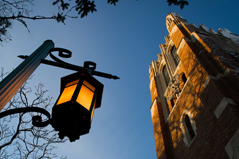 beaumont tower at nighttime next to glowing lantern