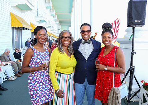 family of four posing for a photo