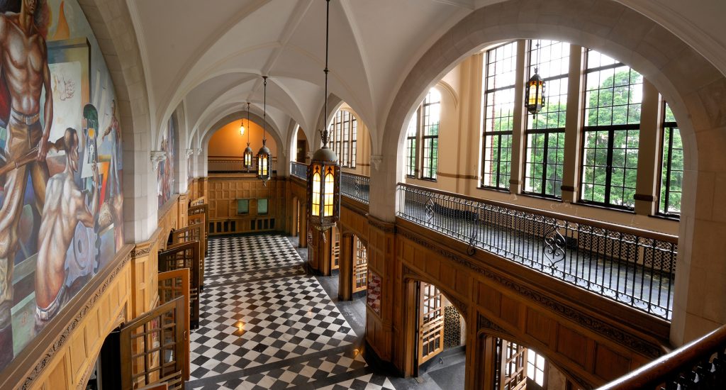 inside of a building with archways and lantern-like lights and checkered floors