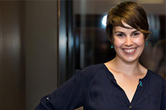 a woman with short hair and navy blue blouse