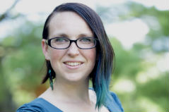 woman wearing glasses and blue top