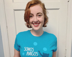 a woman with short hair wearing a blue shirt