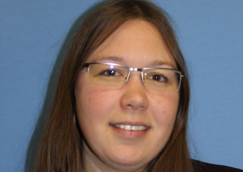 Woman with long dark hair and glasses