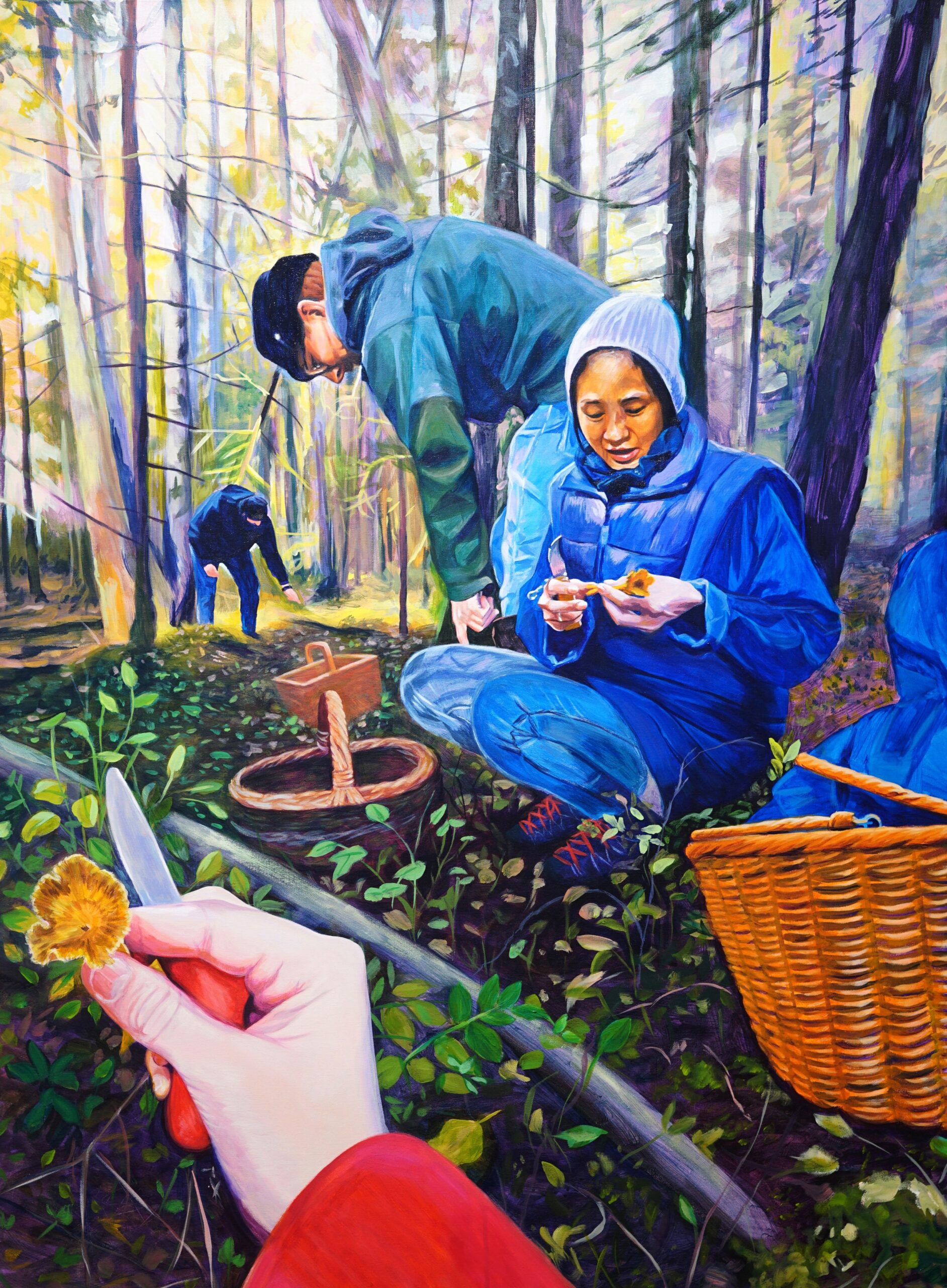 A colorful, expressive painting titled "The Foragers," depicting multiple people harvesting mushrooms in a sunlit forest. In the foreground, a first-person perspective shows a hand holding a small yellow mushroom and a pocket knife. In the middle ground, a woman in a bright blue jacket crouches next to a woven basket, carefully examining a mushroom, while another person in a green hoodie bends over nearby. The background is filled with tall, slender tree trunks washed in soft yellow and purple light.
