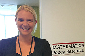 Emily Snoek in front of Mathematica Policy Research sign
