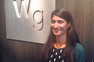 Samara Napolitan in front of Williams Group sign