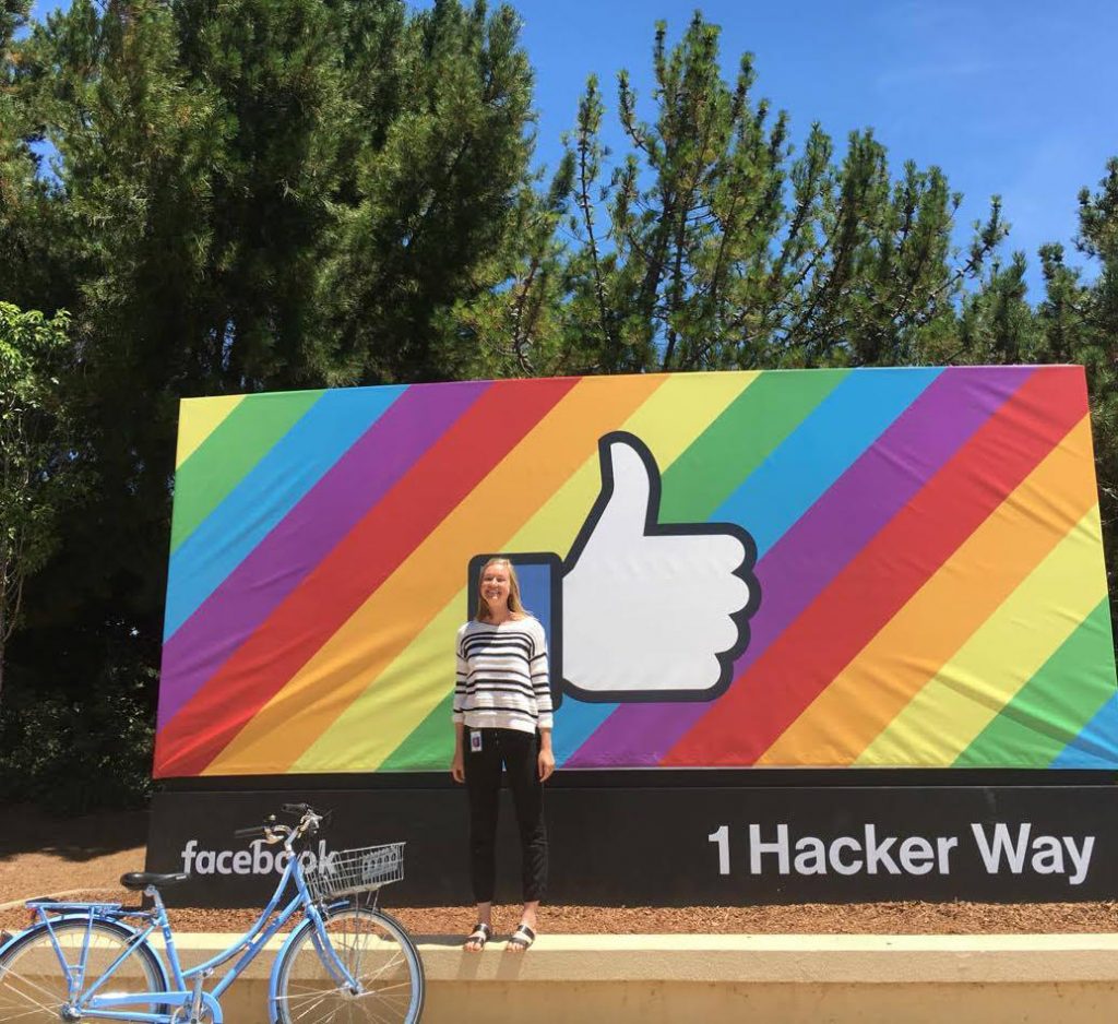Woman with blonde hair in front of a Facebook sign