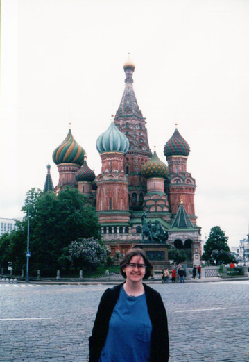 a women standing in front of a building in Russia, showing Russian architecture 