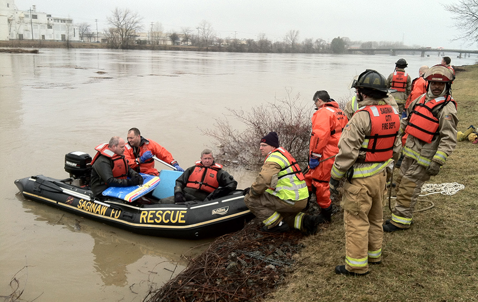 Photo of a group of first responders on a river bank in full uniform