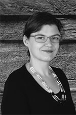 black and white image of a women wearing glasses and a dark shirt 