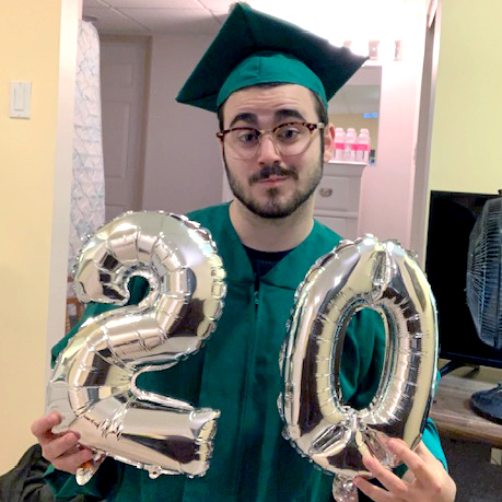 photo of a man wearing a green cap and gown with glasses holding 20 balloons 