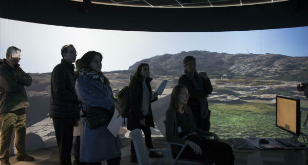 group of people standing in the 360 degree visual immersion room