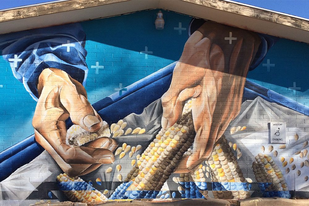 painting of hands peeling corn
