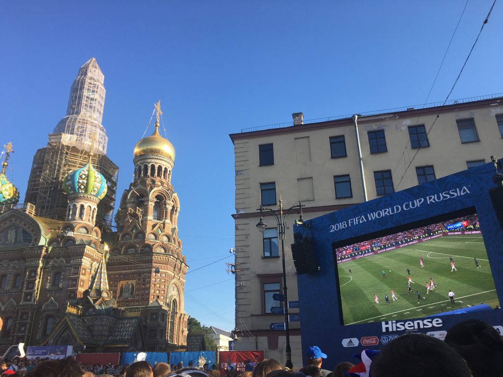 picture of big screen showing the world cup with Russian buildings in the background