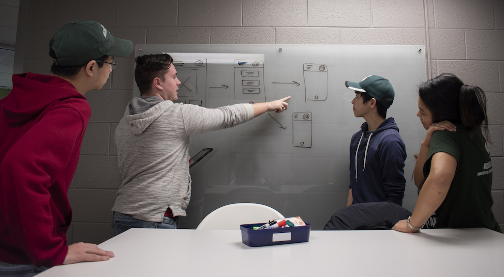 four students working in a class room