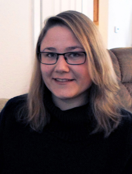 a women with blonde hair wearing glasses and a black shirt