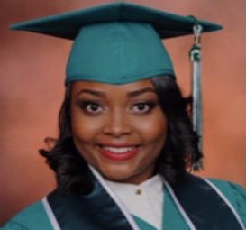 a girl with short dark hair wearing a green cap and gown