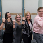 participants pose for photo displaying their fitness trackers on their wrists