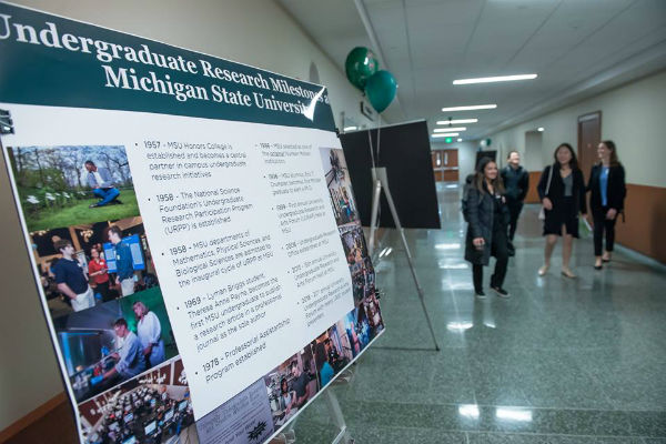 Photo of a poster presentation in a hallway 