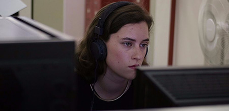 woman wearing headphones working on computer