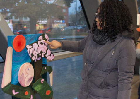 a women touching a piece of artwork
