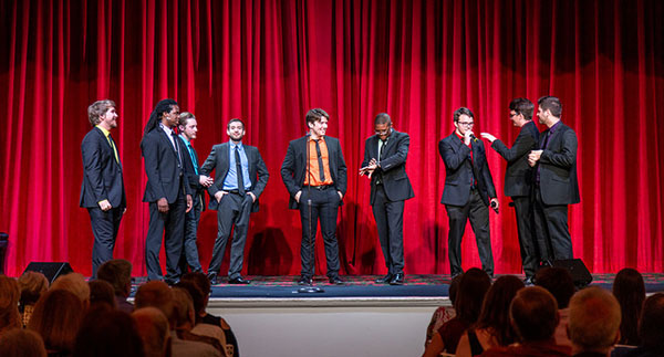 group of men on stage singing