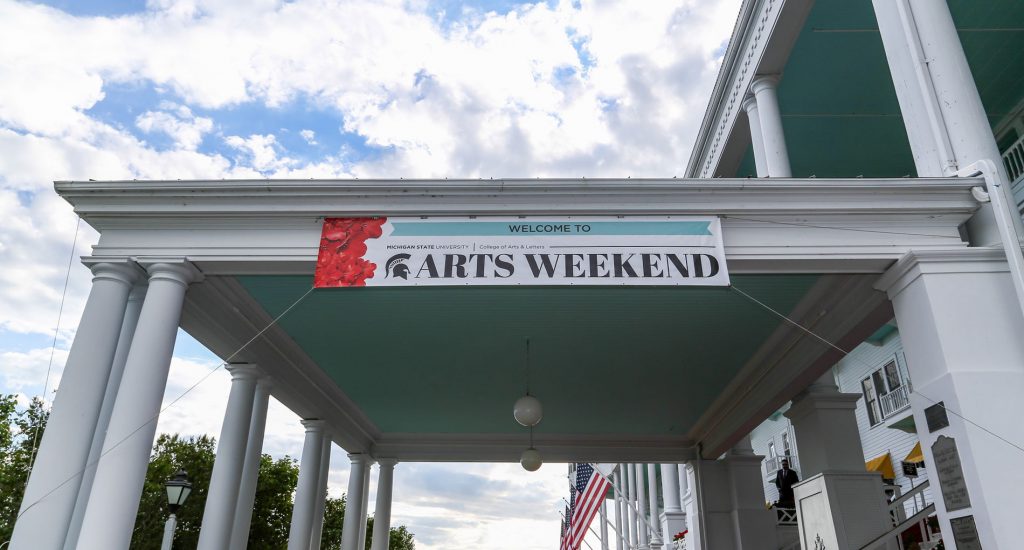 white awning with a sign that says 'arts weekend'
