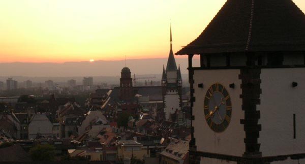 sunset in background with buildings in Freiburg in the foreground