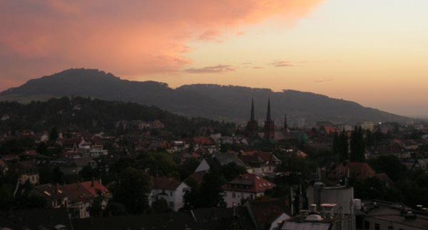 skyline of germany during a sunset, mountains in the distance