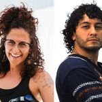 a man with curly hair and a blue shirt with a women with brown curly hair and a black tank top
