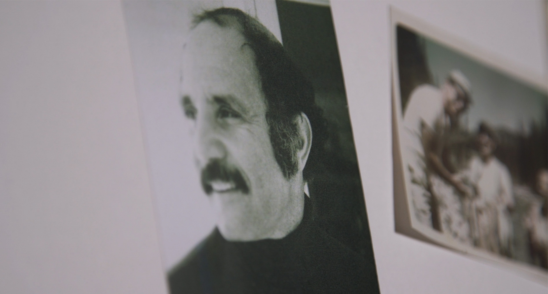 a close-up picture of a photo of a man with a mustache looking into the distance