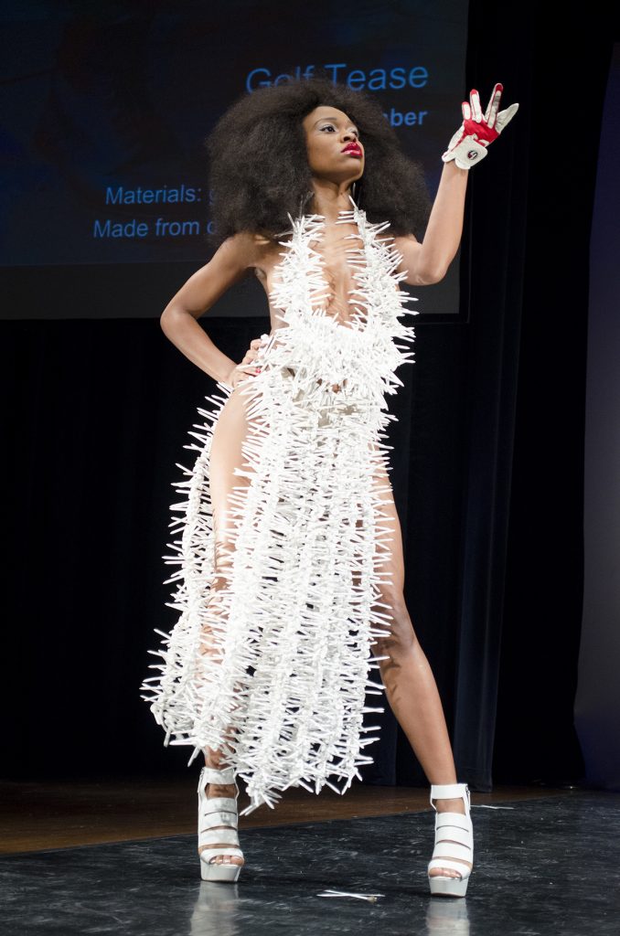A model posed at the end of the runway in a design called "Golf Tease," made of 6,000 golf tees. Photo by Katie Stiefel