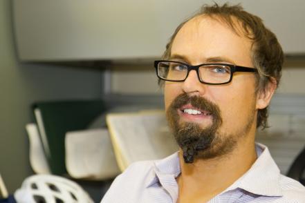 man with facial hair wearing glasses and a white button down shirt