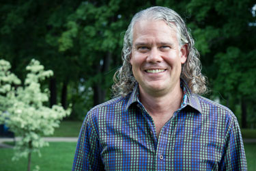 Shawn Loewen: a man with long white curly hair