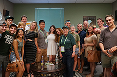 students posing for picture with msu president