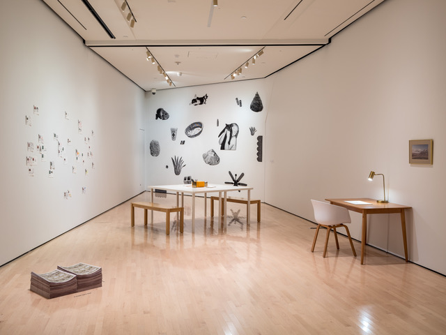 image of Jazzmyn's piece at the broad including tables, chairs, and hangings on walls