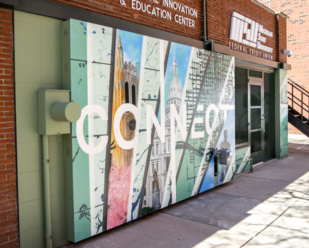 finished mural that says "connect" and has imagery of east lansing and lansing