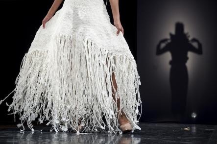 A model posed at the end of the runway in a design called Victorian Wicker, made of white paper. The construction of the design took over 100 hours. Photo by Katie Stiefel