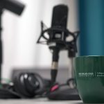 Microphone with Michigan State University mug sitting on table