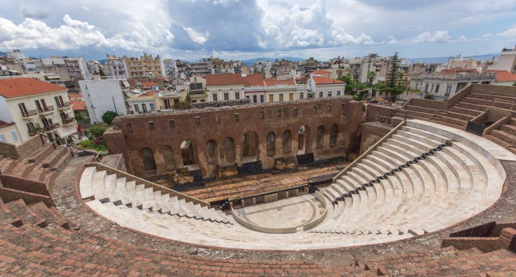 picture of the amphitheater, a red brick theatre with white seats and stairs