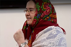 a woman wearing glasses wearing a scarf on her head