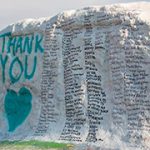 msu rock painted white with teal "thank you" and heart and black signatures