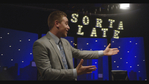 image of a man in a suit talking to an audience with the words "Sorta Late" behind him