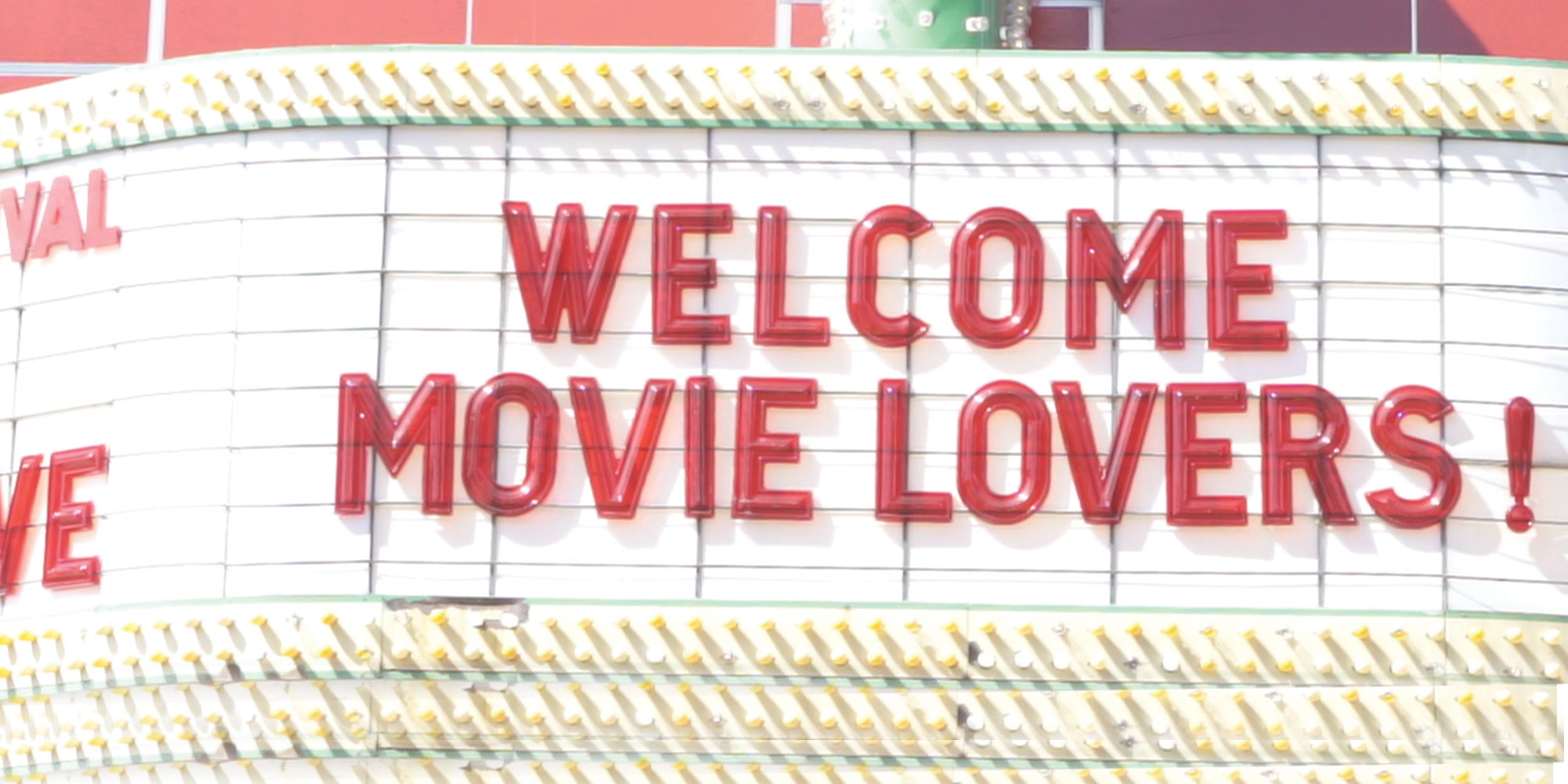 close-up of a picture of a movie theatre display that says 'Welcome movie lovers!'
