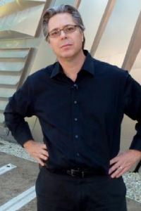 a man wearing glasses in a black button down shirt 
