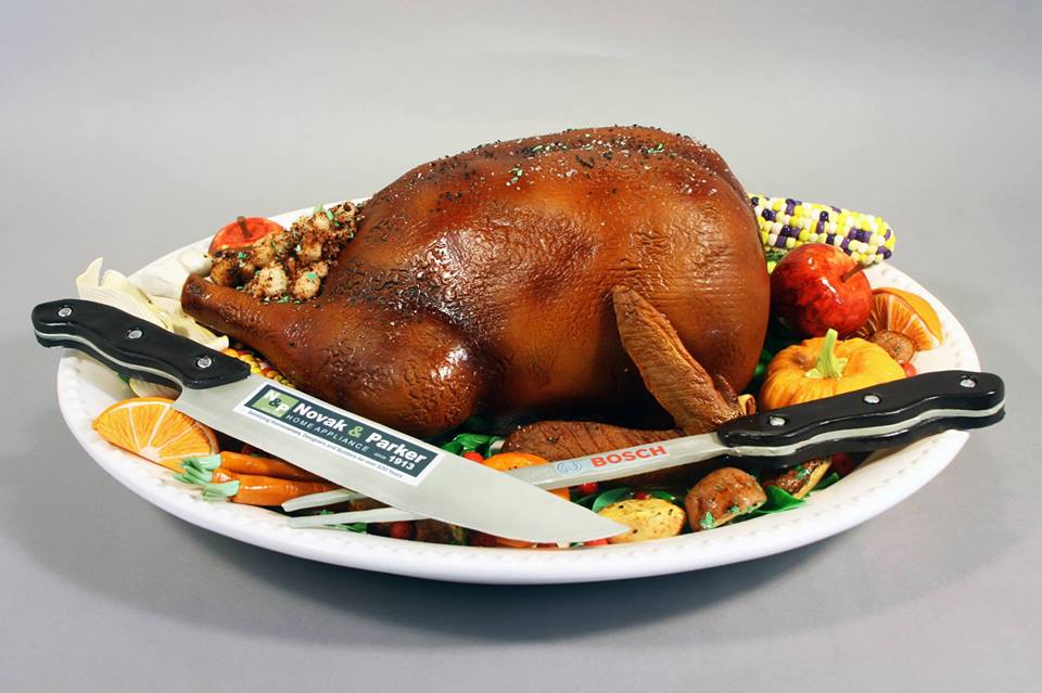 cake that looks like a plate of turkey with vegetables around it 
