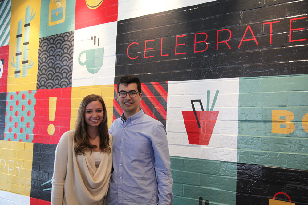 Will Mianecki and Malarie French stand in front of their mural design